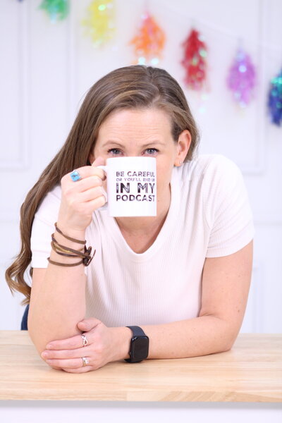 Krystal Proffitt the podcast coach sitting in front of some furniture