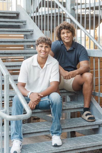 two brothers sitting on stadium steps together