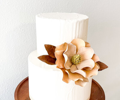 A Magnolia Dried flower Styled on a two tier cake