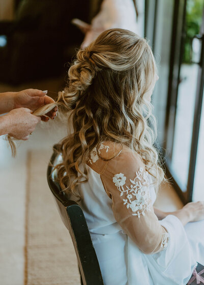 woman styling bride's hair