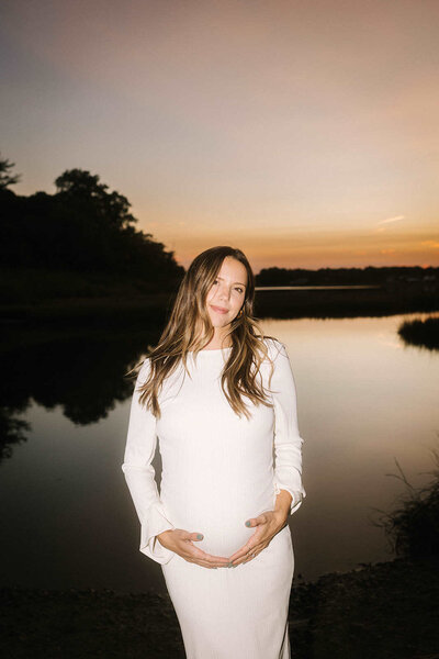 Maternity photography session at sunset by the water in Boston