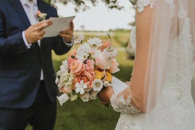 Wedding couple reading vows during their ceremony in Kitchener, Ontario.