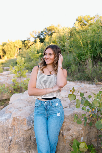 girl poses for senior photos in kansas city missouri