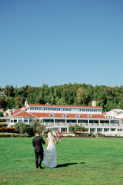 Bride and Groom walking to the Mission Point Resort on Mackinac Island