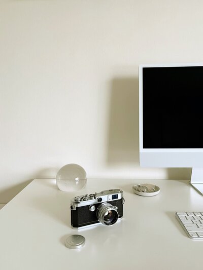 glass dew drop, crystal ball, vintage film camera, iMac, office inspiration, desk of Michigan film wedding photographer Christina Harrison