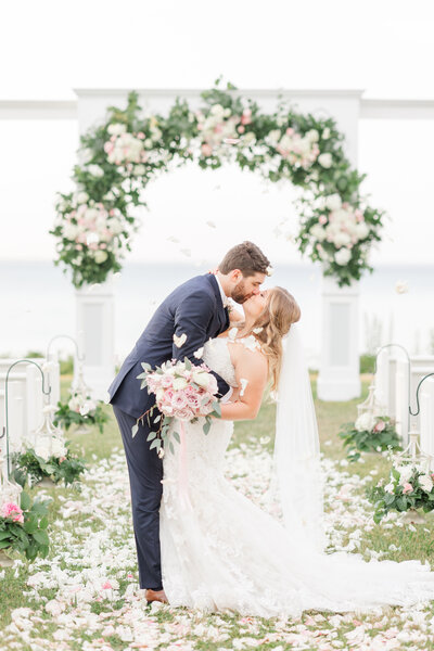 Bride and Groom kiss at the end of the aisle
