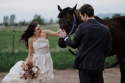 Bride and groom pet horse during Colorado adventure elopement.