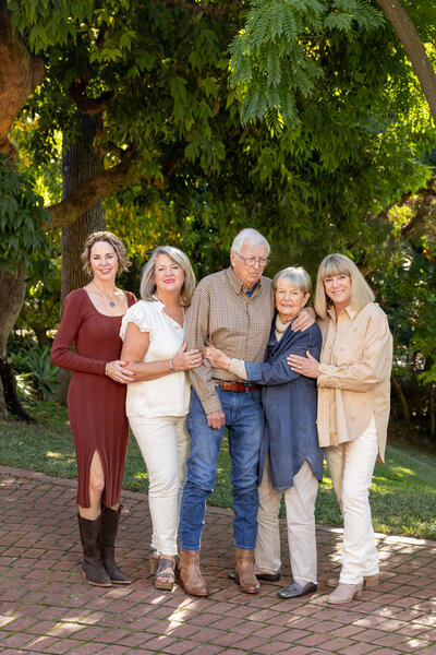 A family of five standing together smiling
