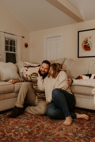 couple sitting on couch and snuggling