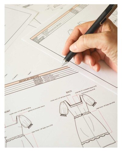 Doreen fashion designer working on a detailed fashion tech pack for women's apparel.