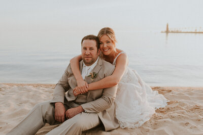 Heather sue and her husband on the beach at their wedding.