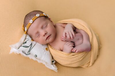 Baby girl posed on yellow