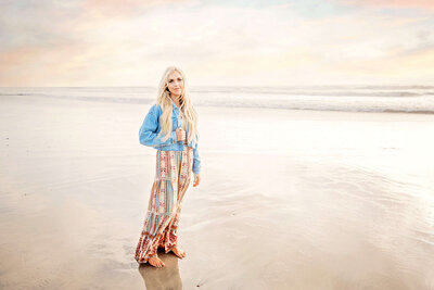 A beautiful senior girl posing at the beach with San Diego senior photographer Tristan Quigley