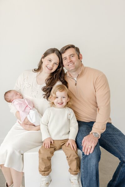 Young girl holding her newborn sister. - Newborn Photography Greenville SC