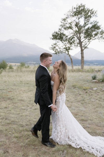 Close up view of delicate wedding dress skirt, wedding bouquet, and heels
