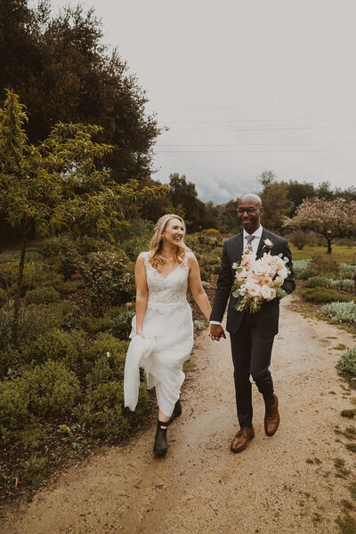 bride and groom holding hands walking