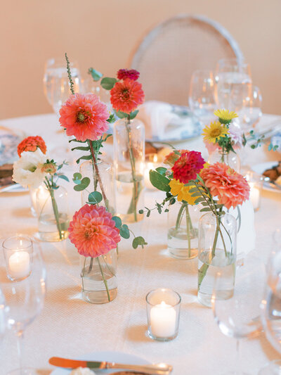 colorful bud vase clusters on table at wedding