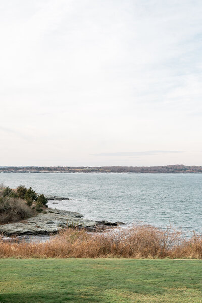 A scenic view of the rocky coastline and sweeping ocean at Oceancliff in Newport, RI, offering a dramatic and romantic setting for a waterfront wedding.