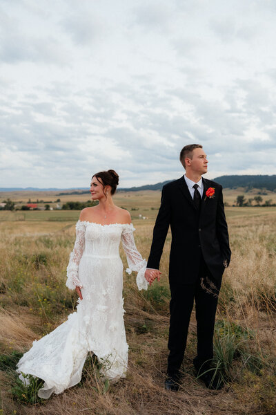 A groom kissing his bride on the forehead.