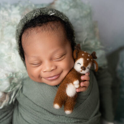 African American Newborn Baby boy wrapped with stuffy