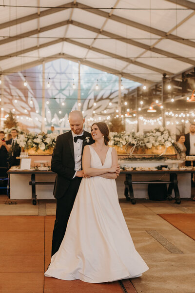 Brunette bride and shaven groom dancing at wedding at Anheuser Busch Biergarten wedding in. St. Louis