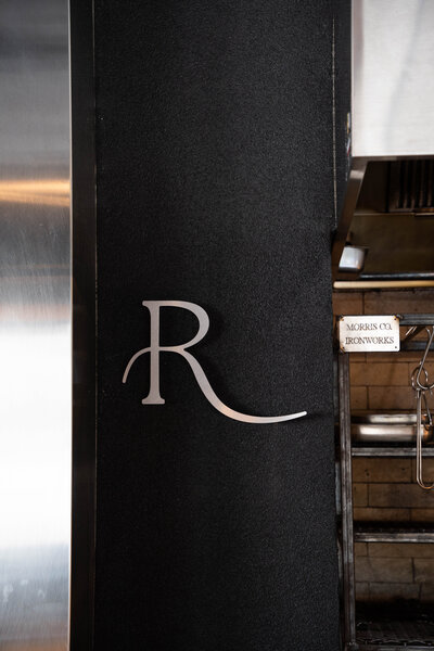 enjoy our open concept live fire farm to table kitchen experience with a flaming hearth inviting you into our intimate yet exclusive dining room