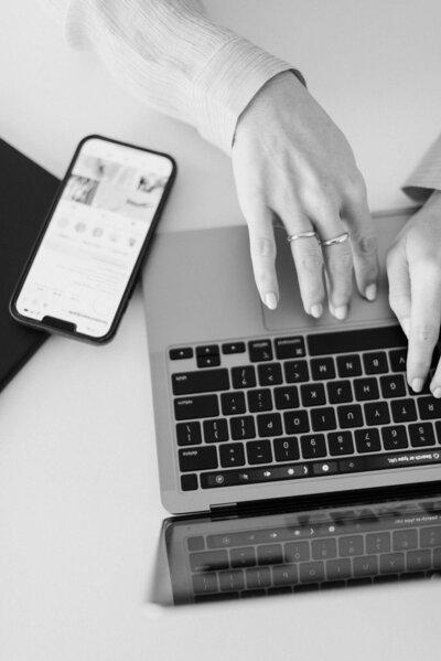 A woman typing on a laptop