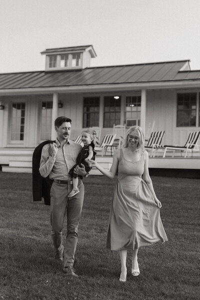 Jess and Corey Combs smiling holding their daughterin Manchester, Vermont