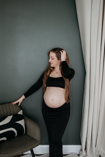 Black Maternity Dress with bump exposed during a maternity studio photoshoot in Bartlett, Illinois