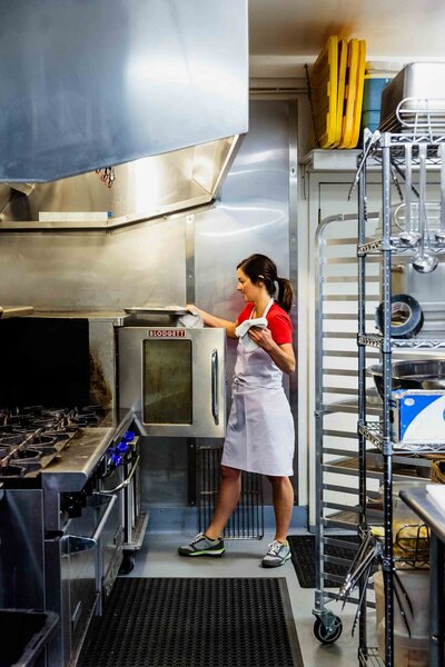 Chef opens oven at Sugar Pine Cakery in Lake Forest in Tahoe City