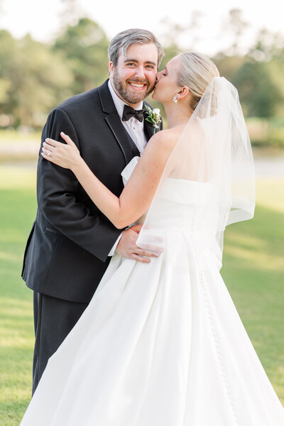 bride kissing groom's cheek