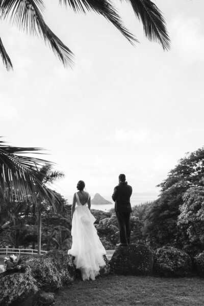 Multicultural ceremony under tropical florals at oceanfront Oahu venue