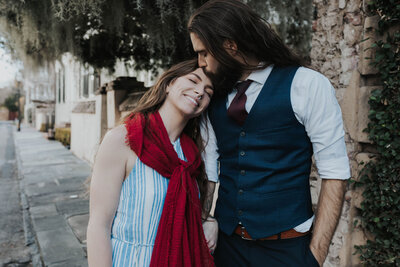 man kisses woman on forehead
