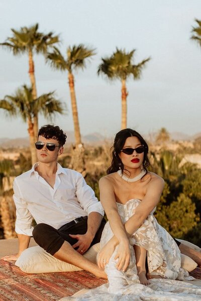 Bride and groom wearing sunglasses on roof top in marrakech