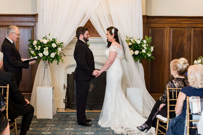 photo of elegant bride and groom exchanging their vows during their Chateau Laurier wedding photographed by Ottawa Wedding Photographer JEMMAN Photography