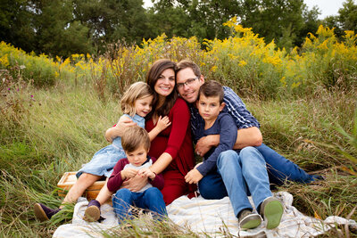 pile on mom and dad at a maternity family session