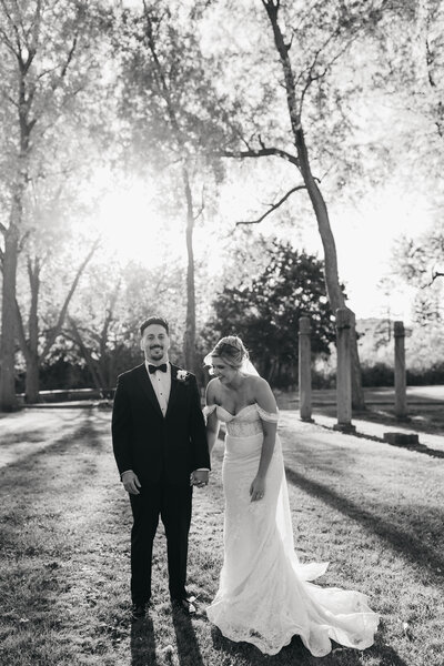 bride and groom laughing at sunset