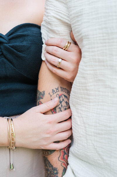 Engaged couple holds hands at Anchorage Trail