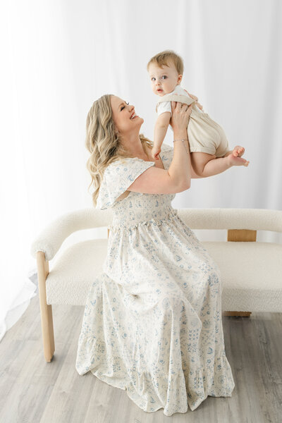 Family gathered around newborn baby during an in-studio lifestyle newborn session — captured by Alliston and Barrie maternity, newborn, and family photographer