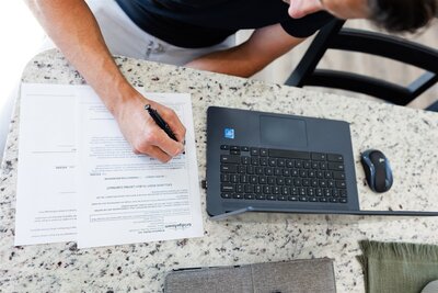 Canon City real estate agent helping negotiate a deal and sign a contract