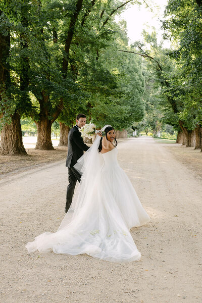 bride and groom leaving walking down long driveway