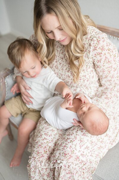 mom kissing newborn baby during a Dallas Newborn Photography session