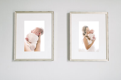 A framed portrait on the wall of a mother holding her baby and kissing his cheek.