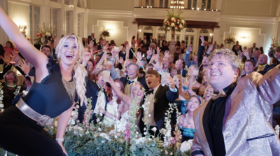 bride, groom, and guests, enjoying a musical performance