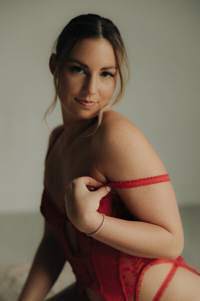 Woman in red lingerie soft smiling at the camera