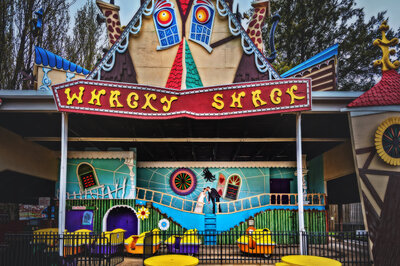 Couple kissing in front of the Whacky Shack at Waldameer in Erie Pennsylvania.