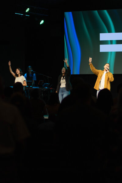 Group of people worshipping at a non-denominational church in Fayetteville, NC. 