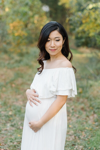 Pregnant woman in pink floral dress - Washington DC Maternity Photographer