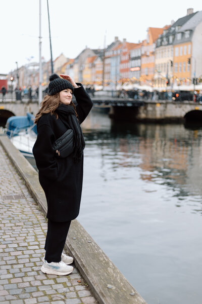 Desiree standing along a canal in Copenhagen, Denmark