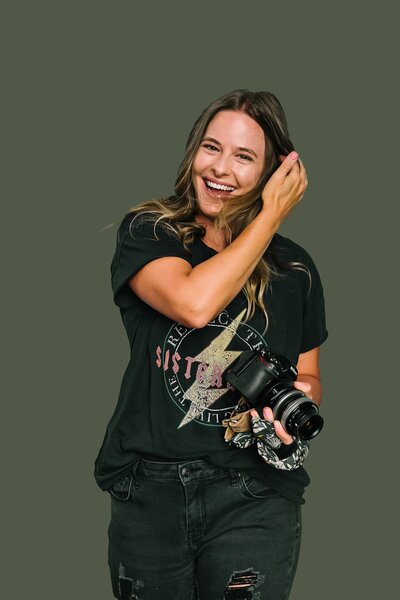 Happy female photographer with camera